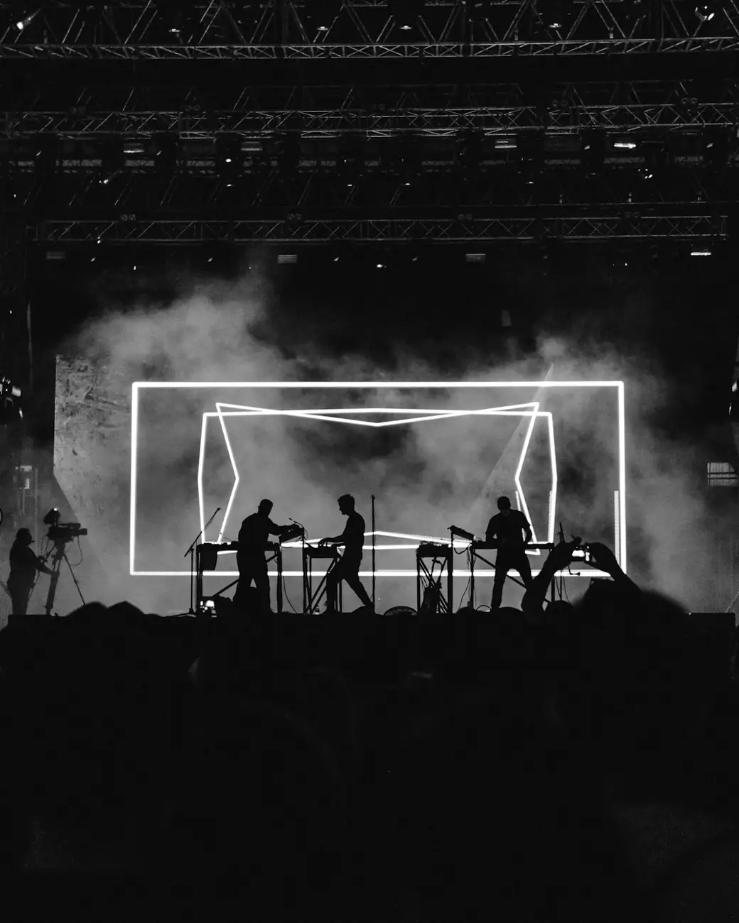 Silhouettes of musicians on a smoke-filled stage