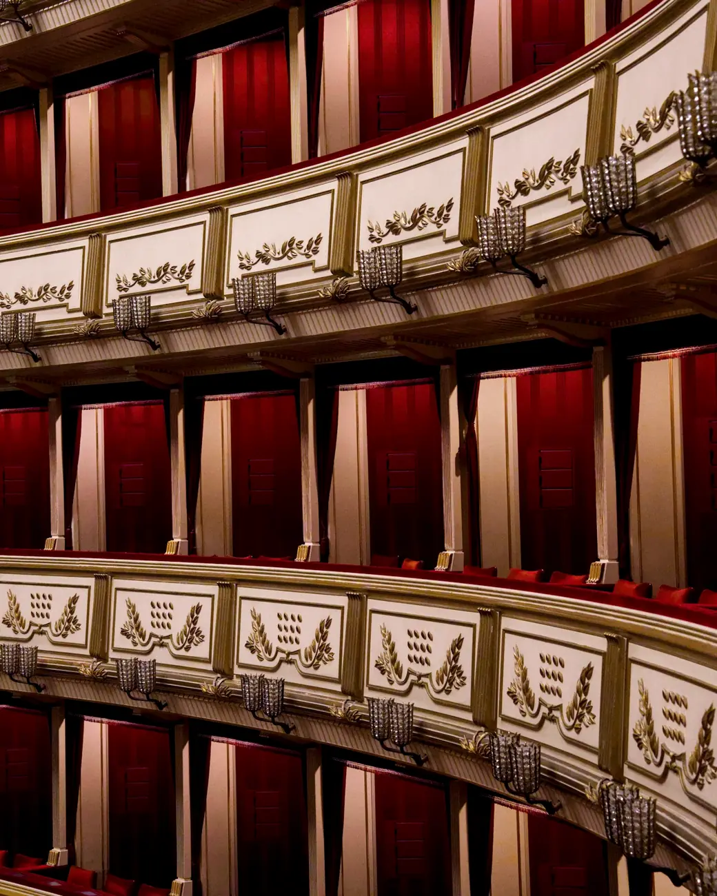 Tiers of opera boxes lined with red velvet